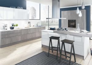 Modern kitchen with white cabinets, island, two bar stools, and stainless steel appliances.
