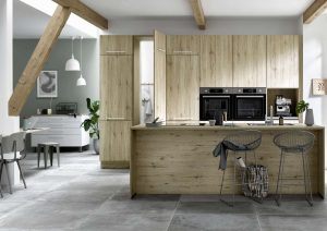 Modern kitchen with wood cabinets, island seating, and open dining area.
