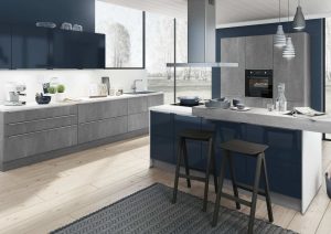 Modern kitchen with blue and gray cabinets, an island, and two stools.