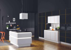 Modern kitchen with black cabinets, white island, and an orange chair on wooden floor.