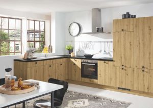 Modern kitchen with wood cabinets, white walls, and a dining table set for breakfast.