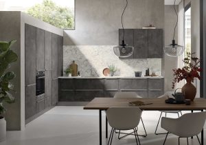 Modern kitchen with dark cabinets, a dining table, plants, and large windows letting in natural light.