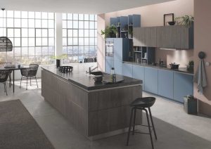 Modern kitchen with blue cabinets, a large island, and big windows letting in natural light.