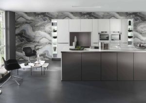 Modern kitchen with dark island, marble backsplash, and built-in appliances.