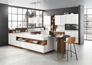 Modern kitchen with white cabinets, wood accents, island seating, and large windows.