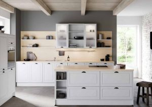 Modern kitchen with white cabinets, open shelves, and a kitchen island in a bright, airy room.