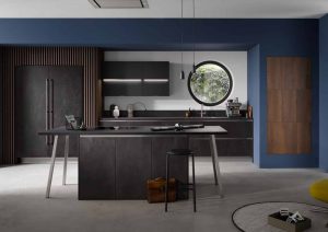 Modern kitchen with dark cabinets, a round window, and blue walls.