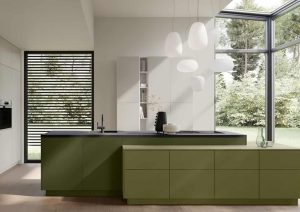 Modern kitchen with green cabinets, large windows, island, and hanging pendant lights.