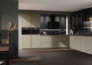 Modern kitchen with beige cabinets, black countertops, and built-in appliances in a sleek, open space.