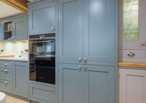 Light blue cabinets and a built-in oven in a modern kitchen.