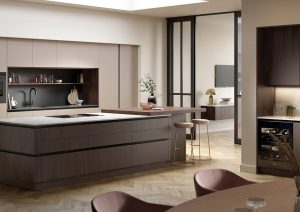 Modern kitchen with a large island, built-in appliances, and neutral-colored cabinets.