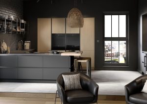 Modern kitchen and living area with dark cabinets, a window, and two black armchairs.